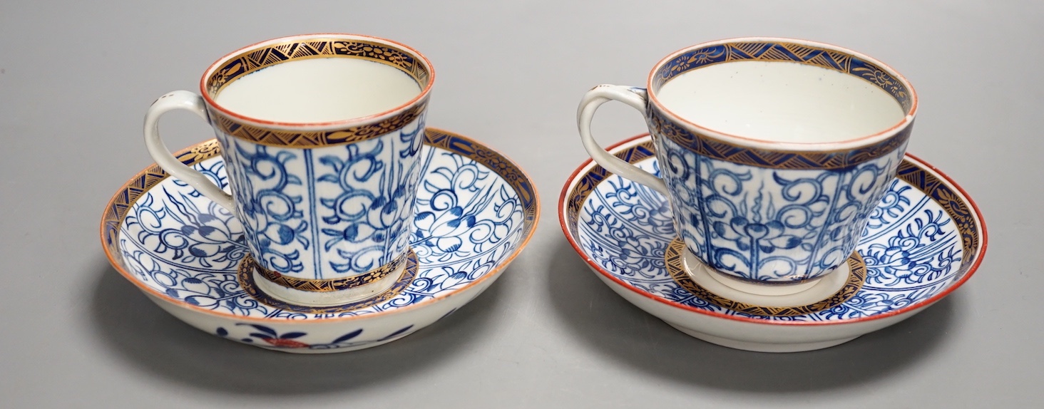 A Worcester coffee cup and saucer of rare Sevres shape with entwined handle painted with the Royal Lily pattern with an unusual central design and a Worcester conical coffee cup and saucer painted with another version of